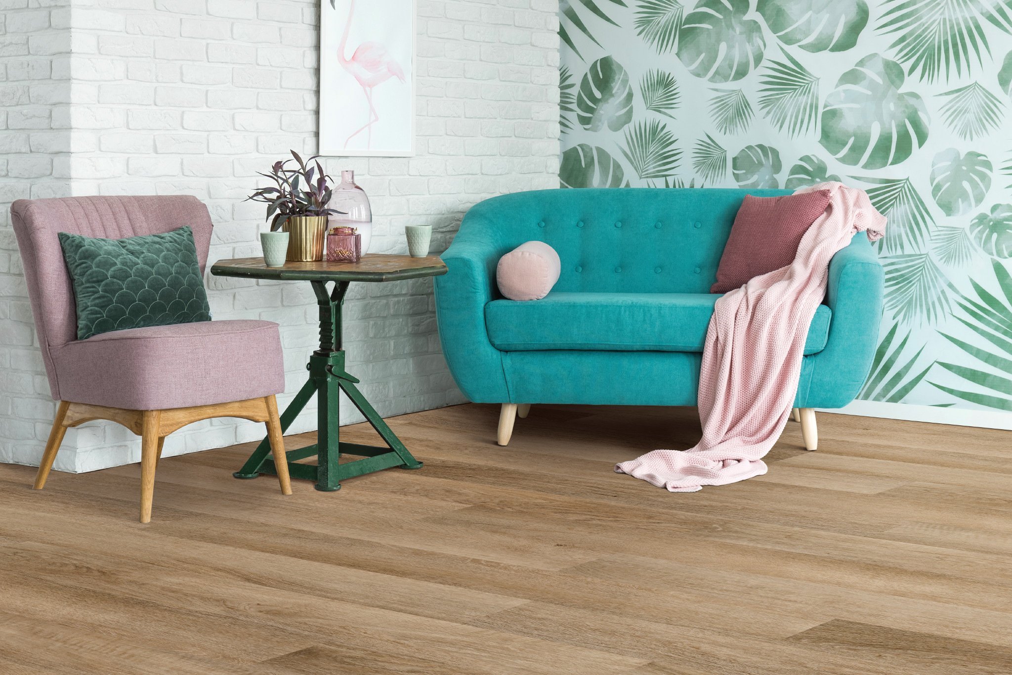 turquoise couch and pink chair on brown hardwood floor from Butler Floors in the Austin, TX area