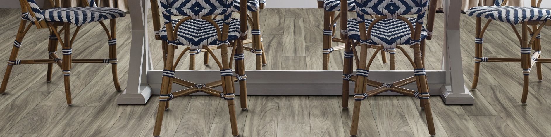 woven dining chairs around a dining table from Butler Floors in Austin